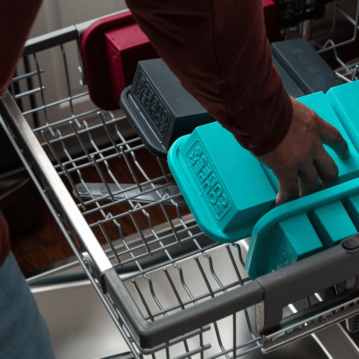 Removing cleaned freezer trays from the dishwasher
