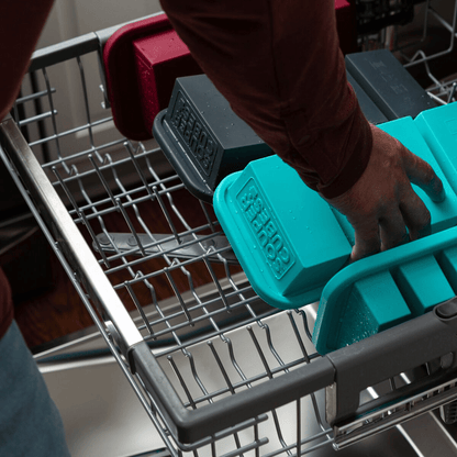 Removing cleaned freezer trays from the dishwasher